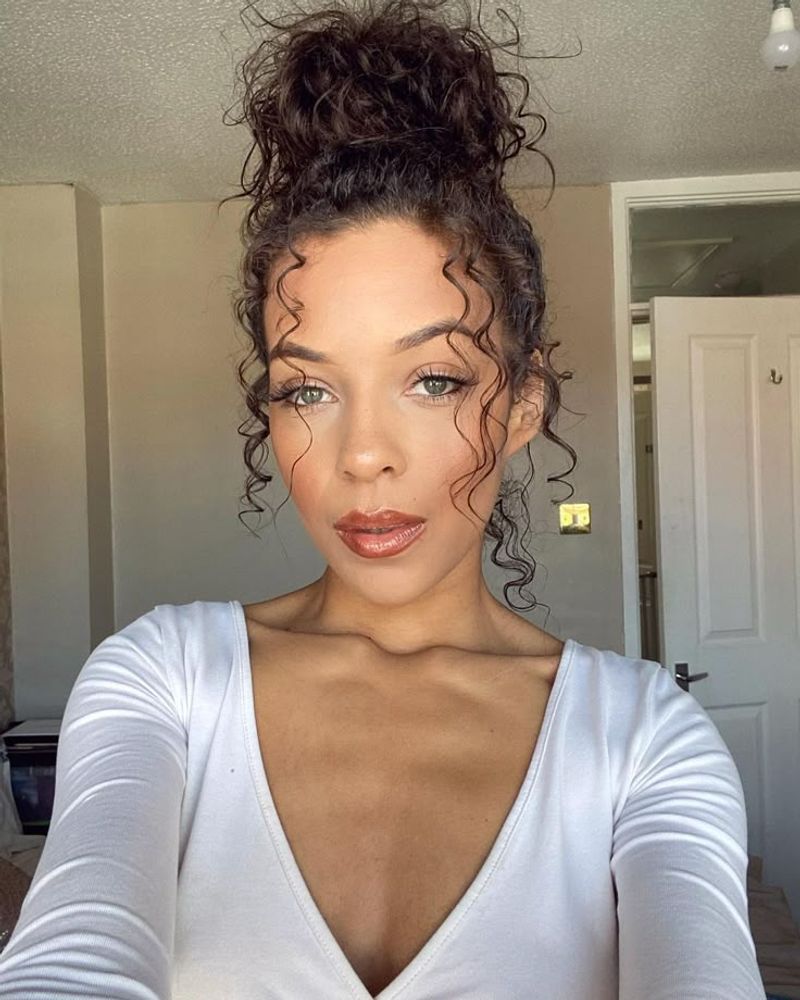 16. Messy Curly Topknot